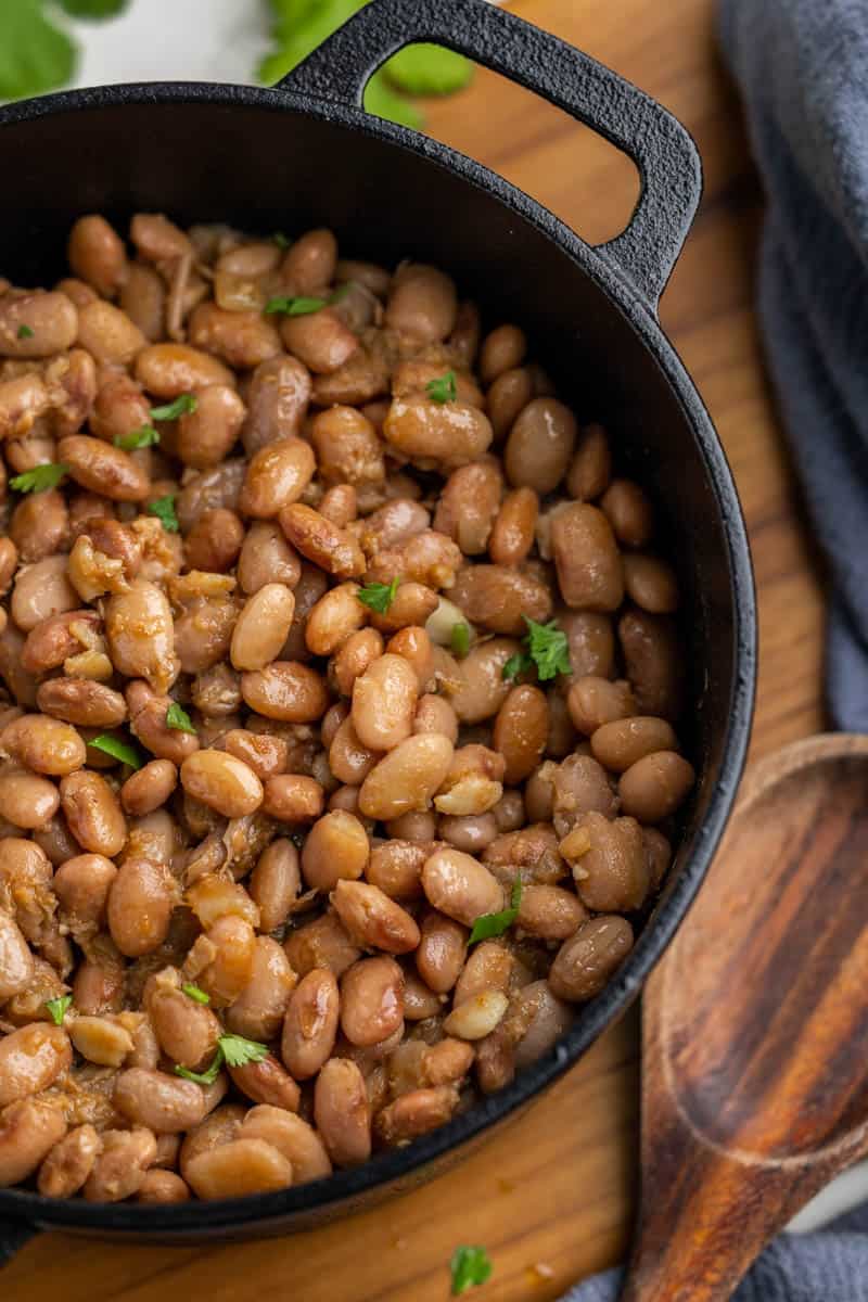 Overhead view of pinto beans in a cast iron pan.