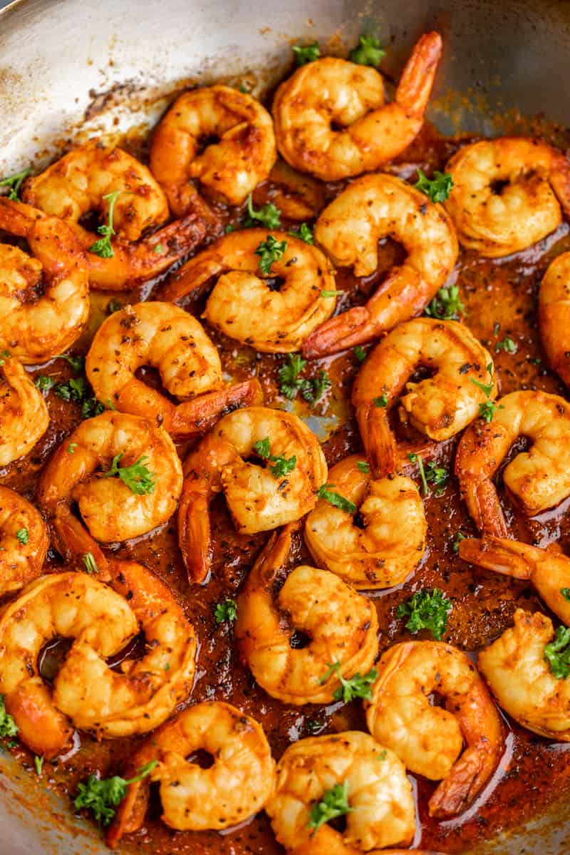 Overhead view of sautéed shrimp in a skillet.