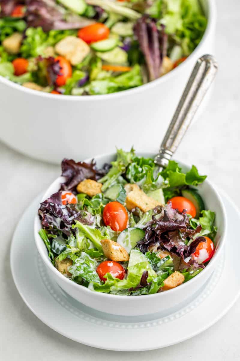 A simple side salad in a white salad bowl.