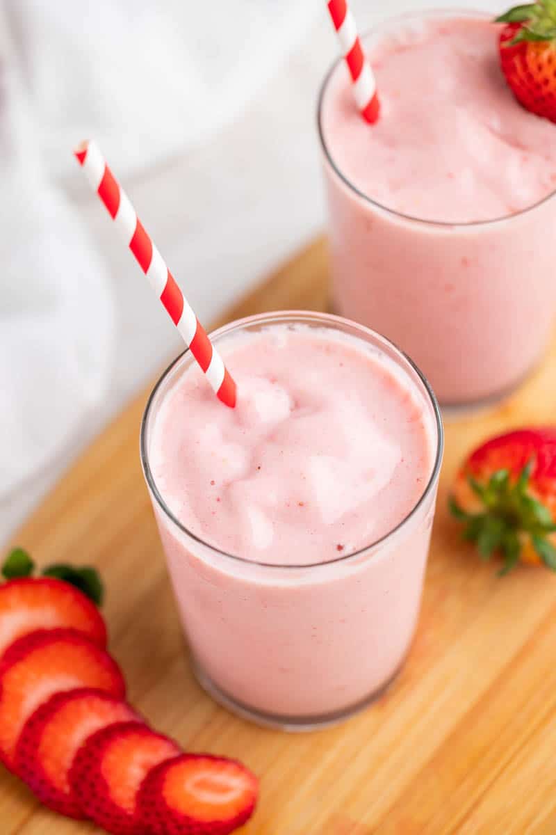 An overhead view looking into a glass full of strawberry smoothies.