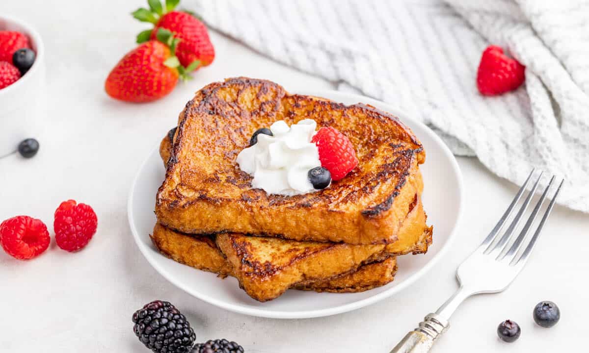 Crème brûlée french toast stacked on a white plate.
