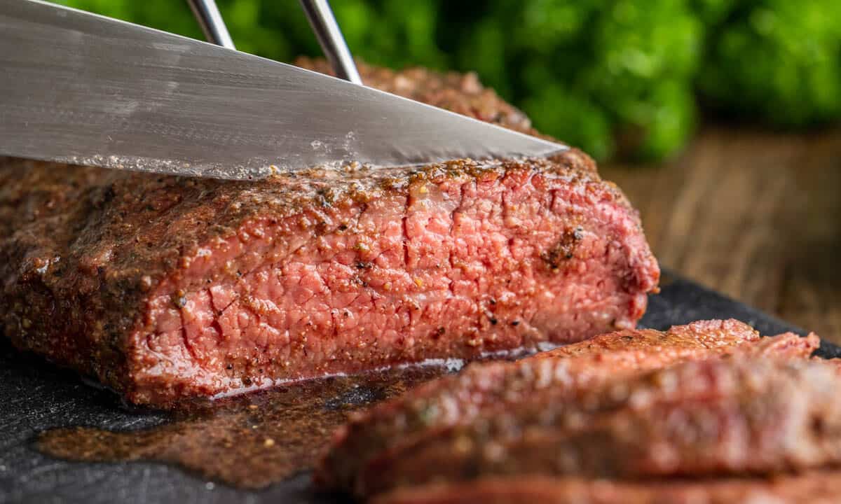 Tri tip being cut with a sharp knife.