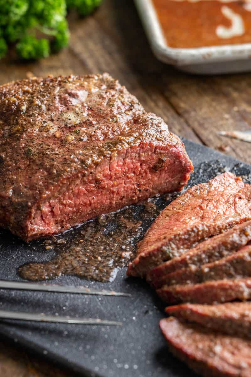 Cut the smoked tri-tips into slices.