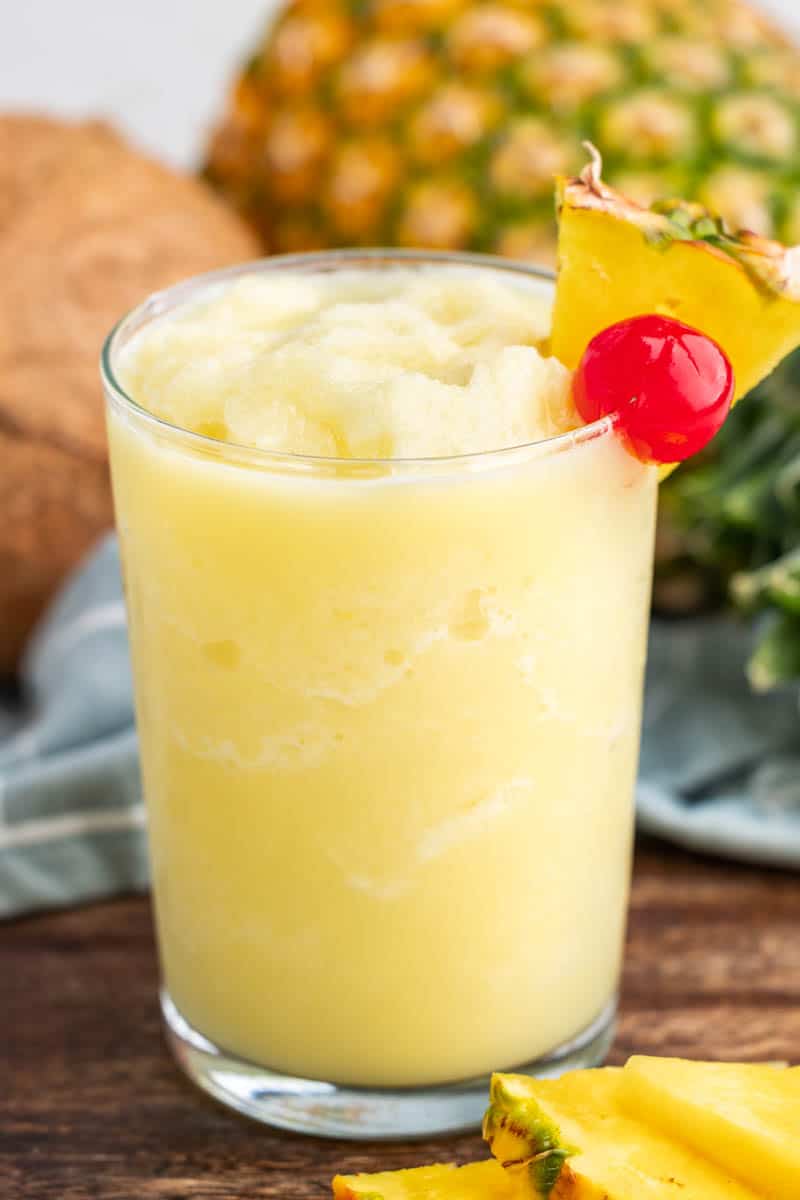 Close up view of a virgin Pina colada in a glass with a pineapple wedge.