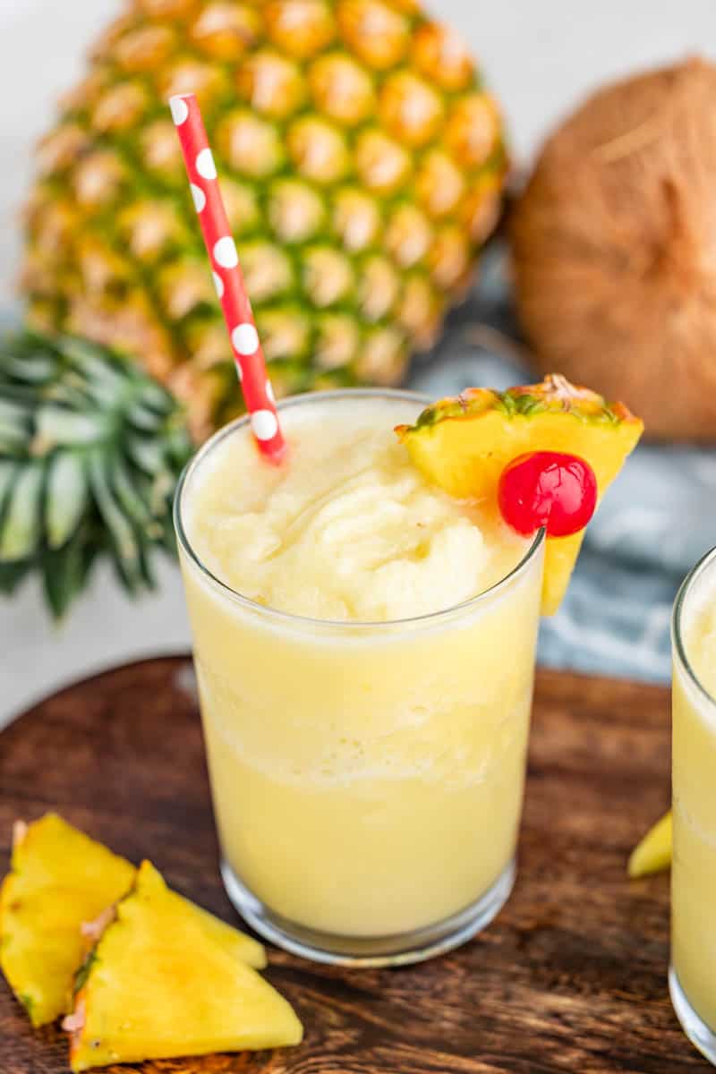 Virgin Pina colada in a glass with a paper straw.