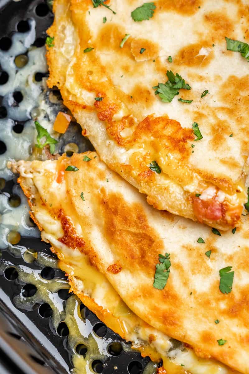 Overhead close up view of a quesadilla in an air fryer.