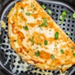 An overhead view of a quesadilla in an air fryer basket.