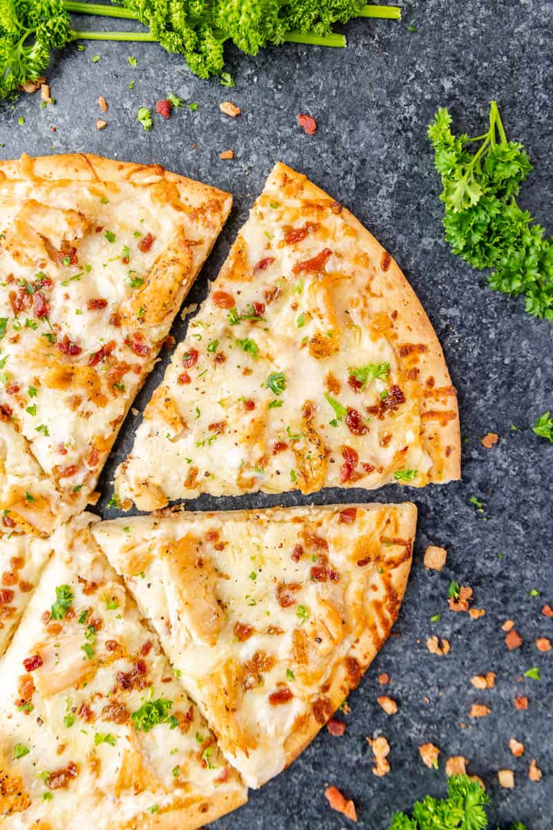 Overhead view of chicken alfredo pizza.