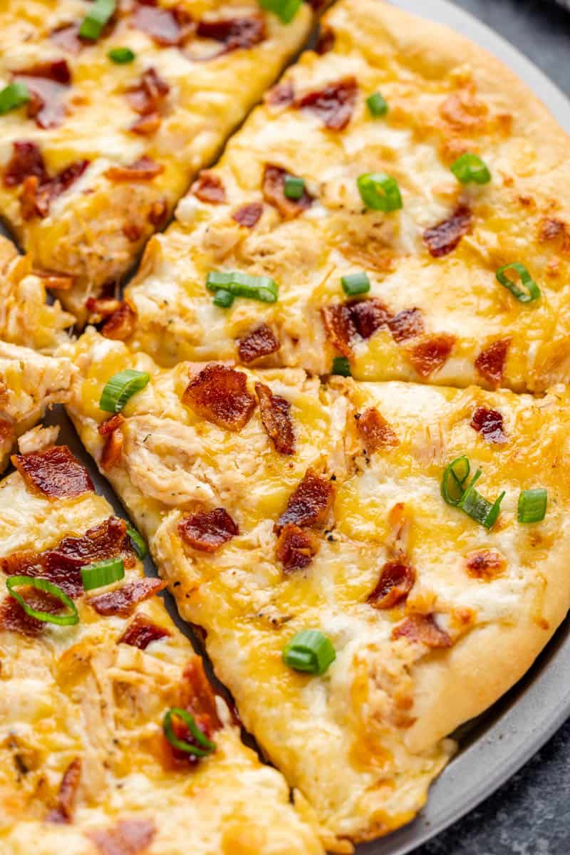 Close up overhead view of a chicken bacon ranch pizza.