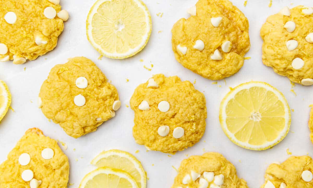 Overhead view of lemon slices and lemon cookie on a counter.