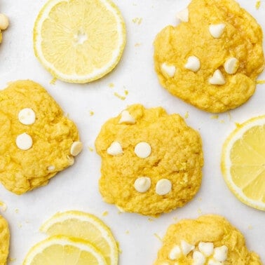 Overhead view of lemon slices and lemon cookie on a counter.