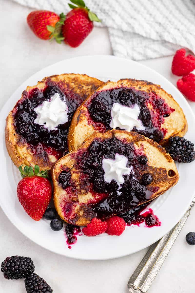 Overhead view of sourdough French toast with fresh berry jam on top.