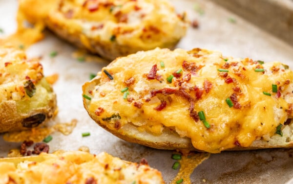 Close up view of twice baked potatoes on a baking sheet.
