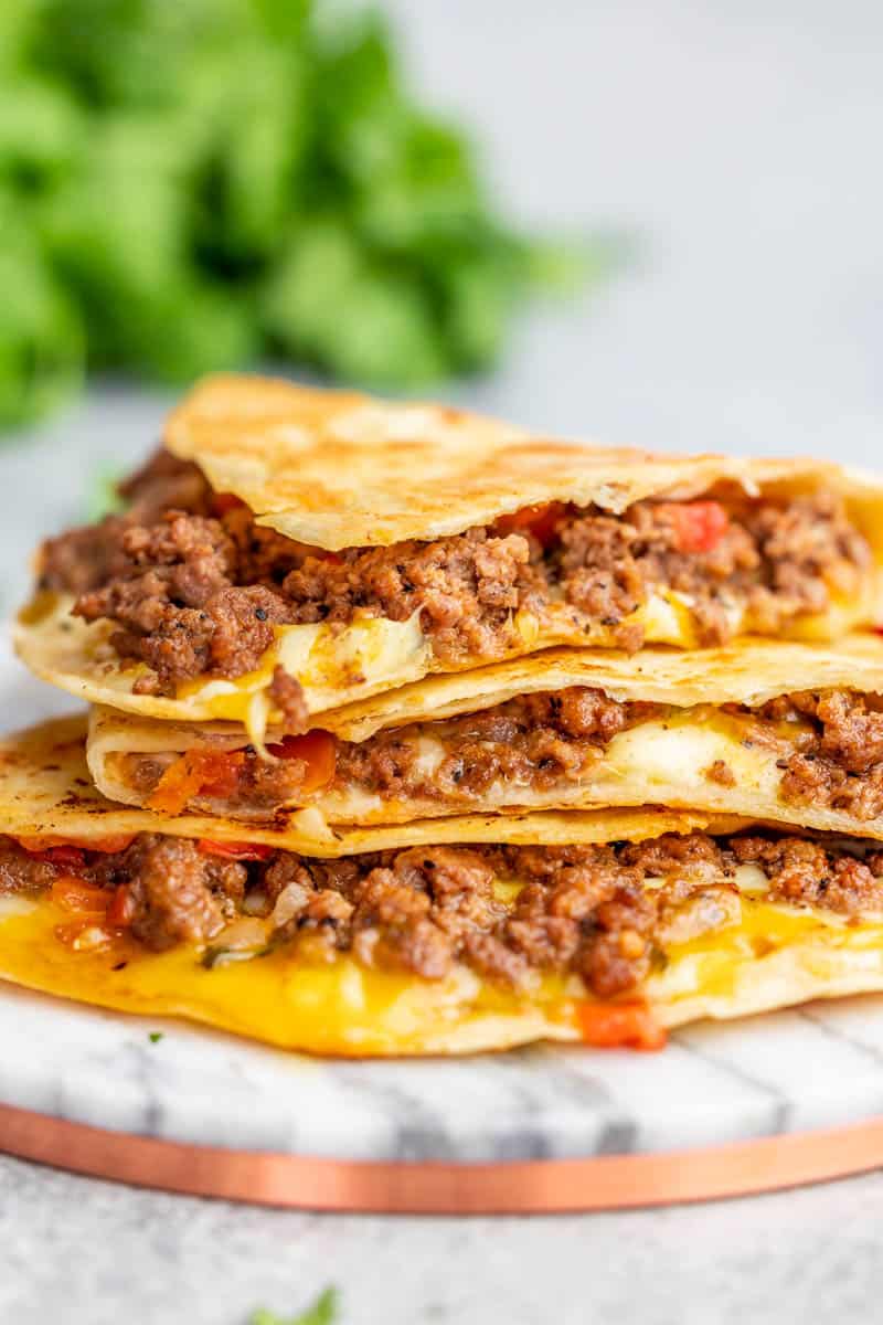 Beef quesadilla slices stacked on top of each other.