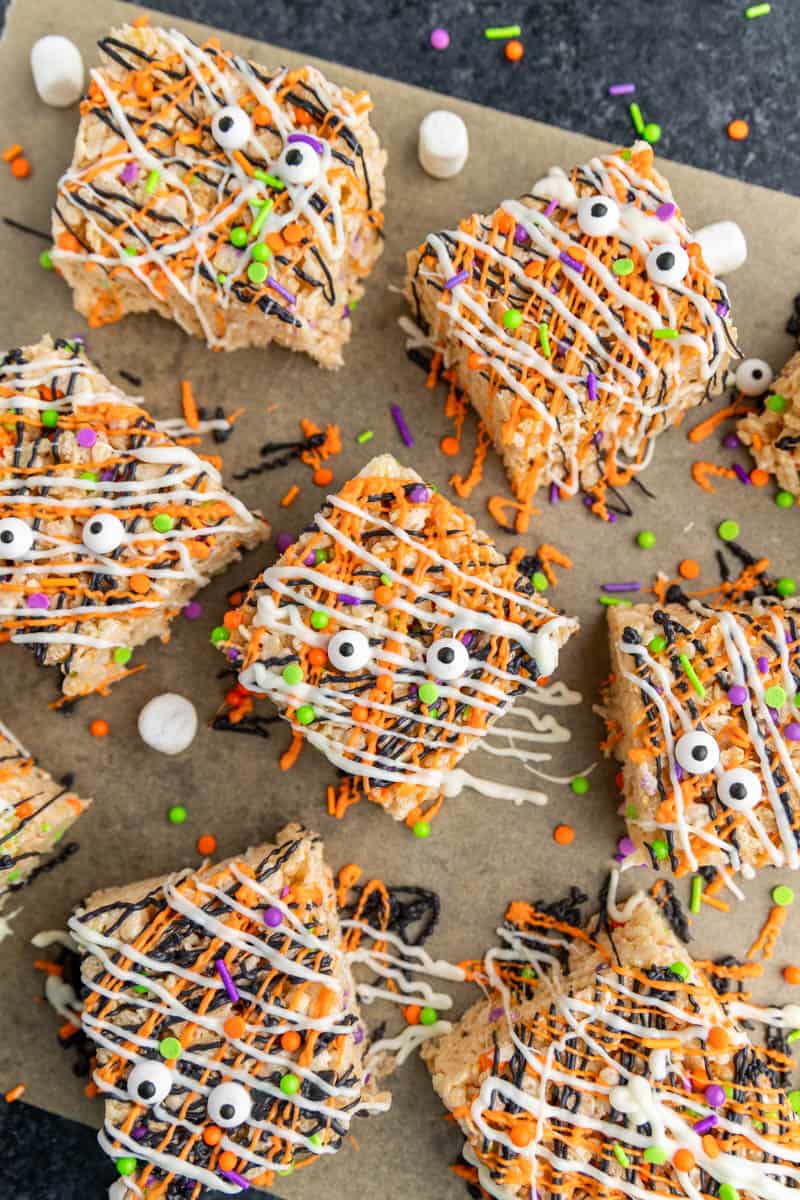 Halloween decorated Rice Krispie treats on parchment paper.