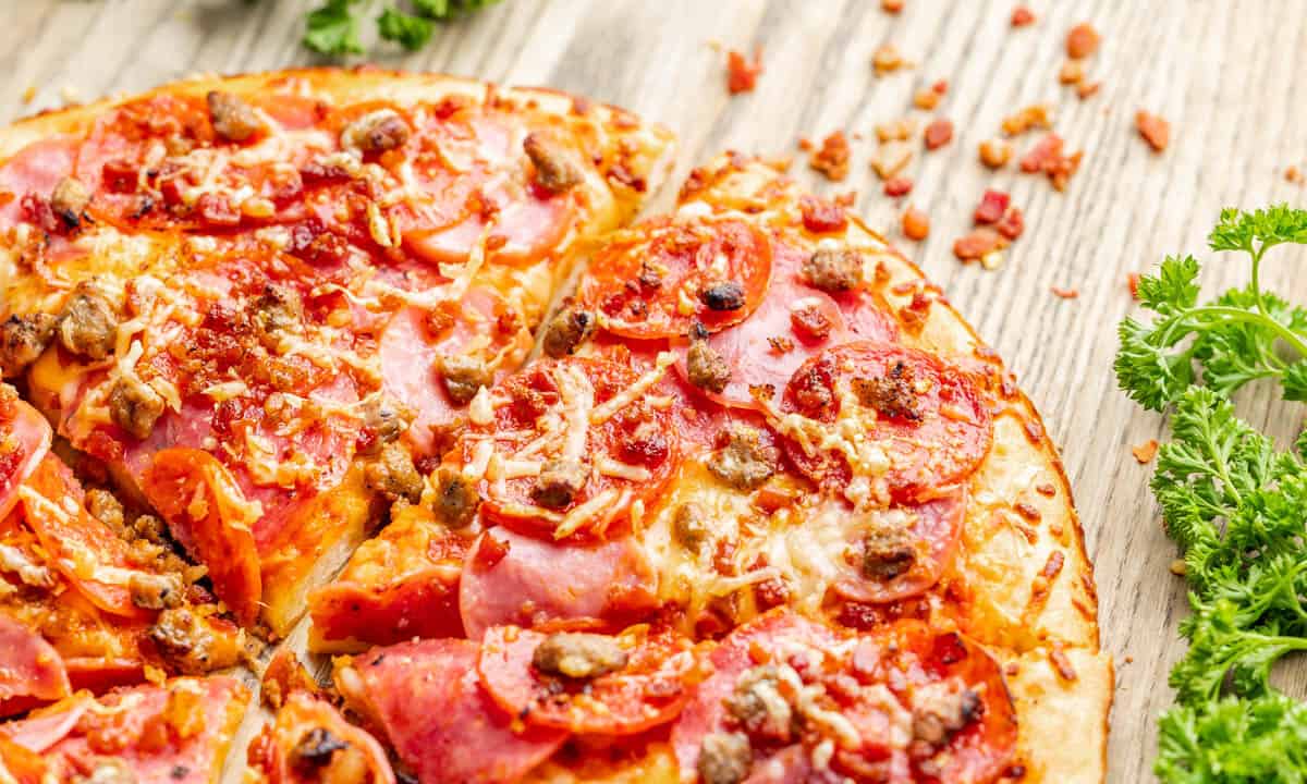 Close up overhead view of a meat lover's pizza.