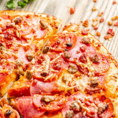 Close up overhead view of a meat lover's pizza.