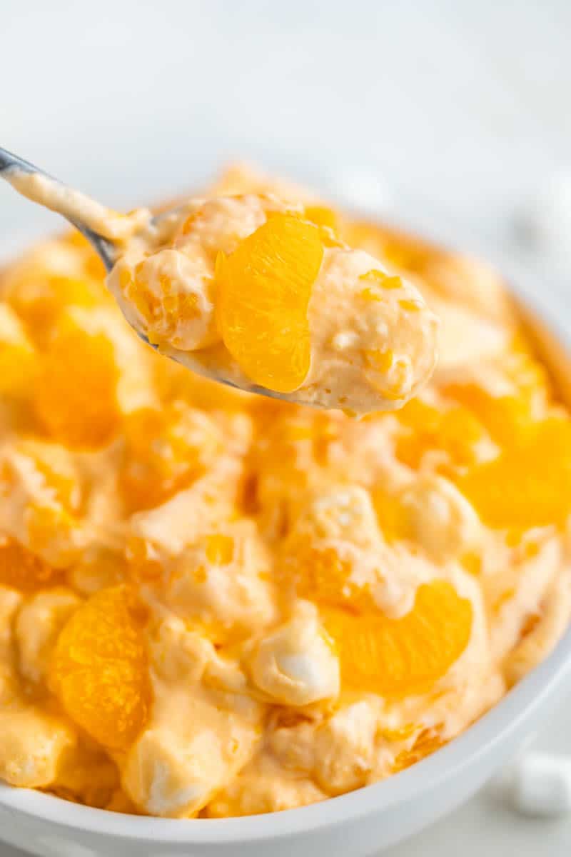 A spoonful of orange creamsicle salad.