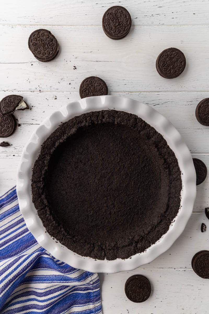 A homemade Oreo cookie crust in a pie plate.