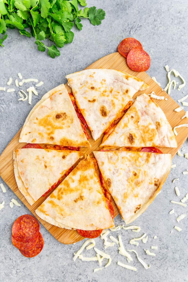 Overhead view of a pizza quesadilla in slices.