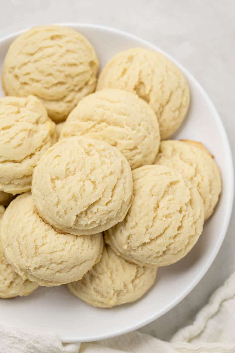 A white plate filled with drop-style sugar cookies.
