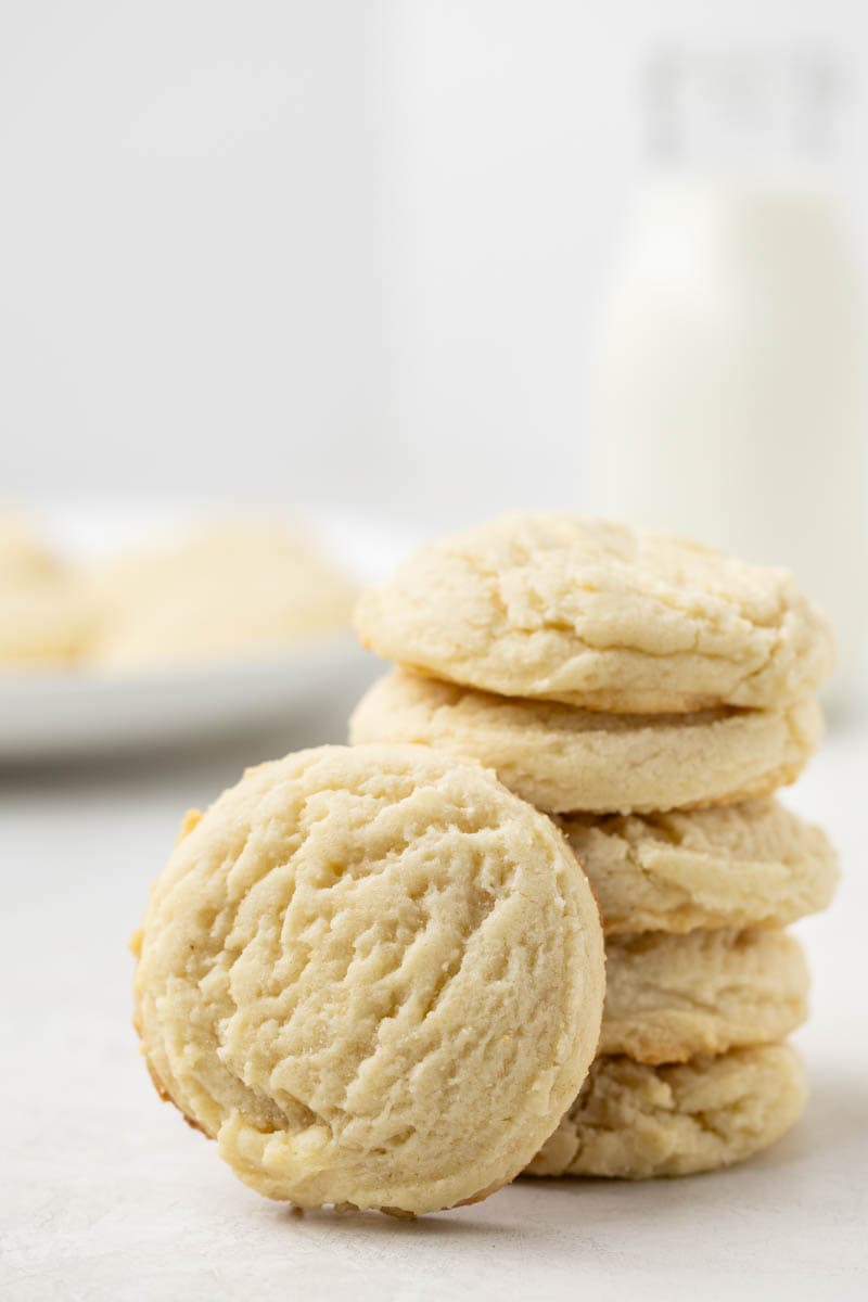 A stack of drop-style sugar cookies on a counter.