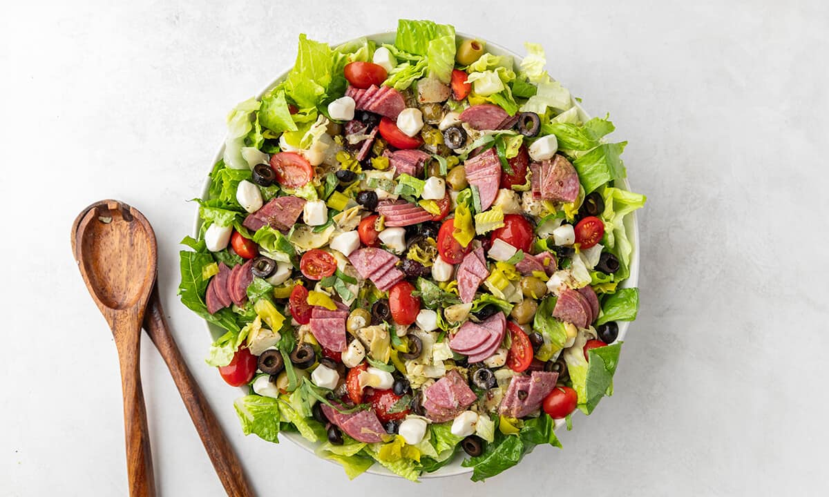 Overhead view of an antipasto salad in a serving bowl.