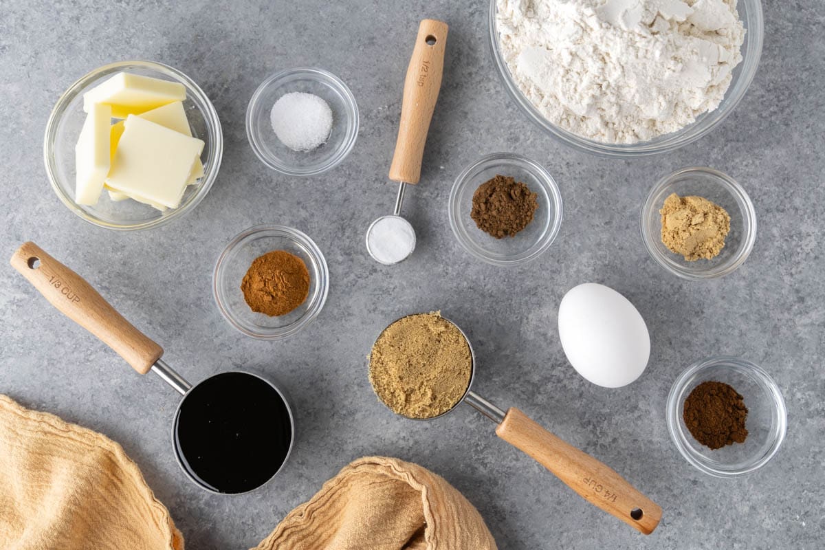 Raw ingredients on a clean kitchen counter to make homemade gingerbread cookies.