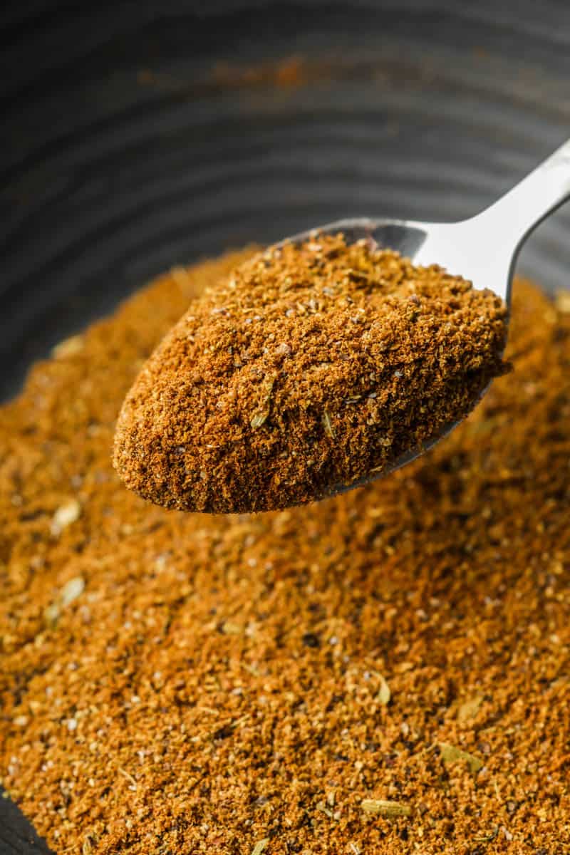 A spoonful filled with homemade garam masala.