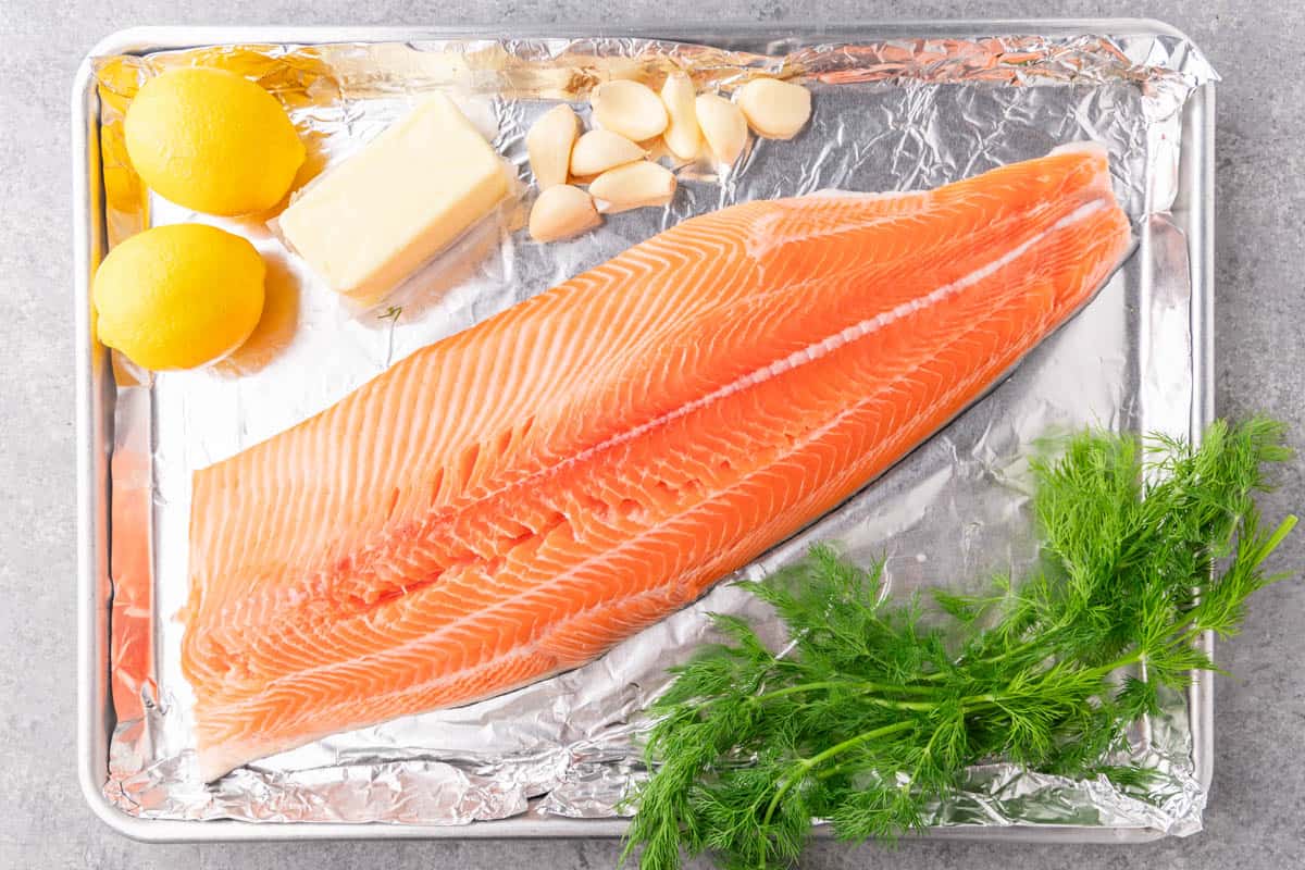 An overhead view of the raw ingredients needed to make baked salmon.