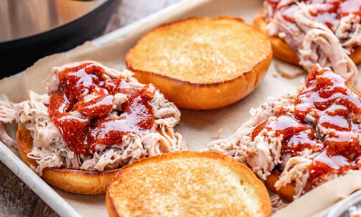 Close up view of homemade pulled pork sandwiches with bbq sauce.