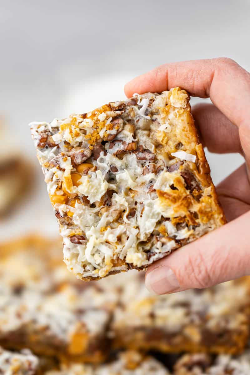Looking straight on at a hand holding a 7 layer bar.