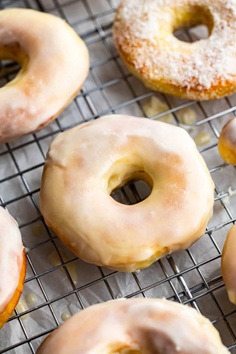 Overhead view of glazed donuts on a cooling rack.