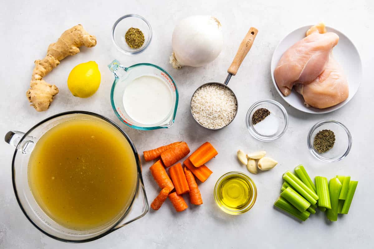 An overhead view of the ingredients needed to make chicken and rice soup.