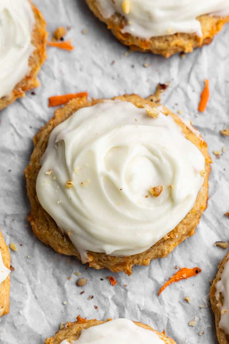 Overhead view of a carrot cake cookie with cream cheese frosting on top.