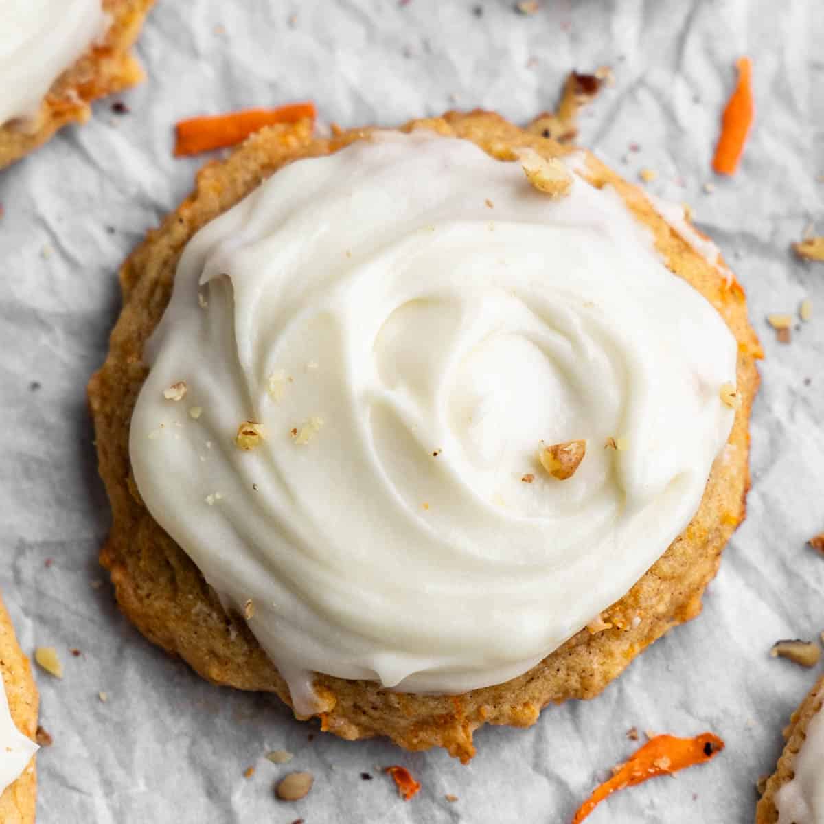 Overhead view of a cream cheese frosted carrot cake cookie.
