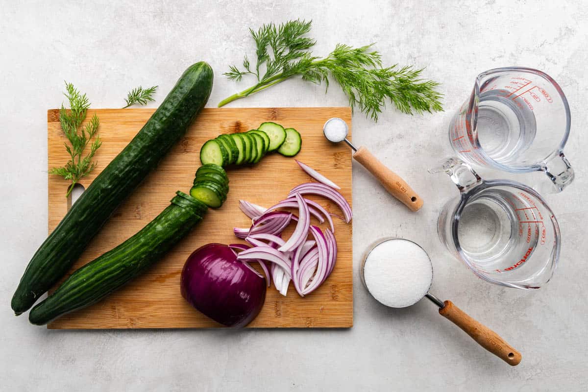 An overhead view of the ingredients required to make the associated recipe for cucumber salad.