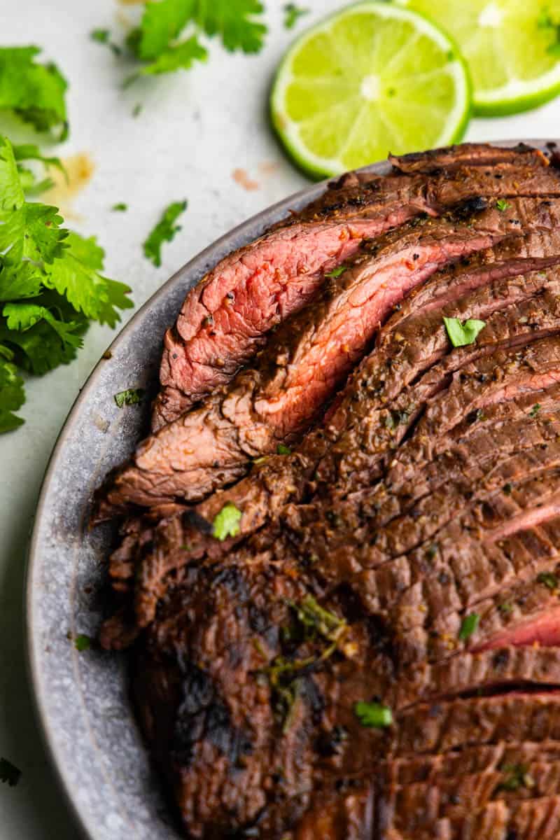 A close up overhead view of marinated, grilled, and sliced carne asada fresh off the grill. 