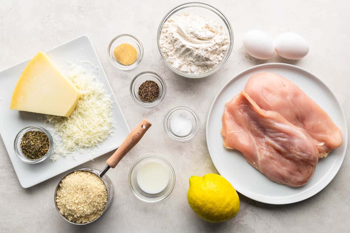 An overhead view of the ingredients needed to make chicken cutlets. 