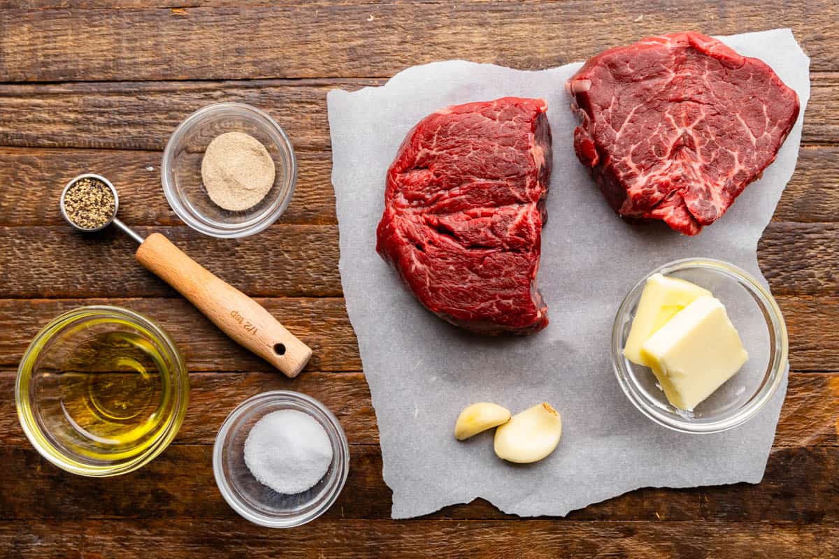 An overhead view of the ingredients needed to make a perfect filet mignon steak. 