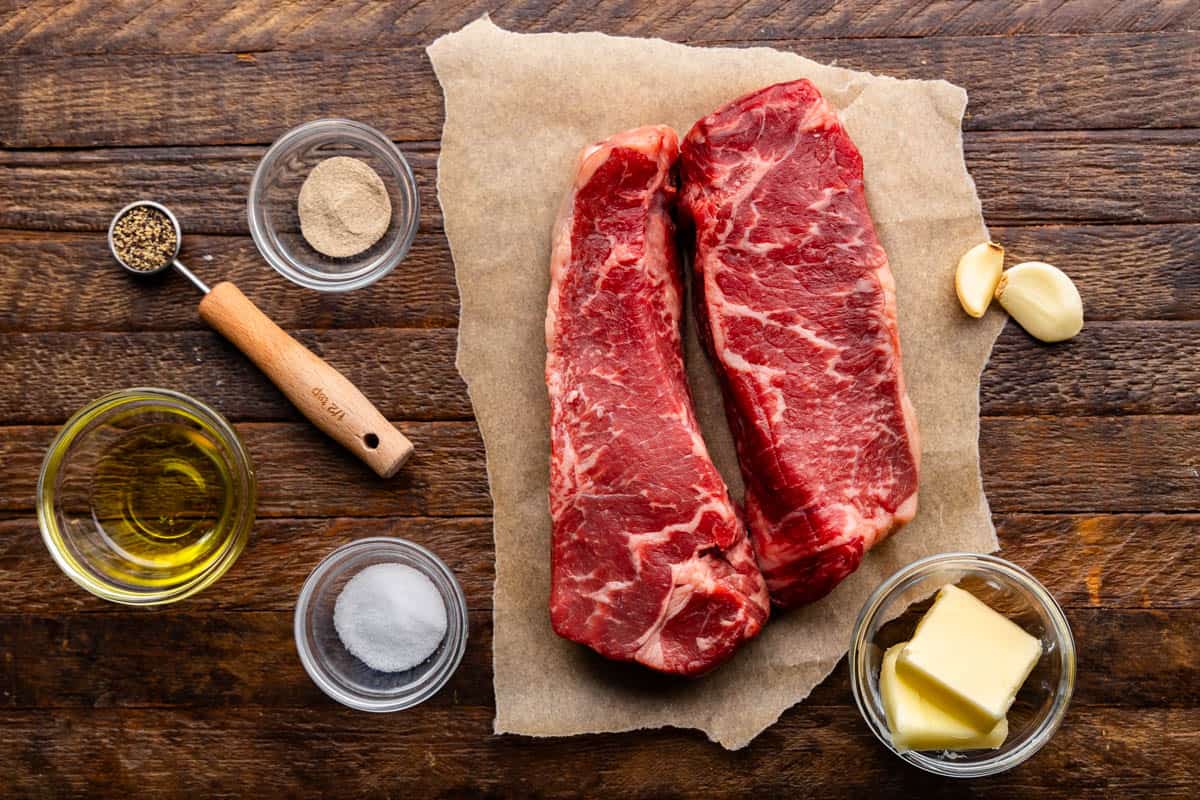An overhead view of the ingredients needed to make a perfect New York strip steak. 
