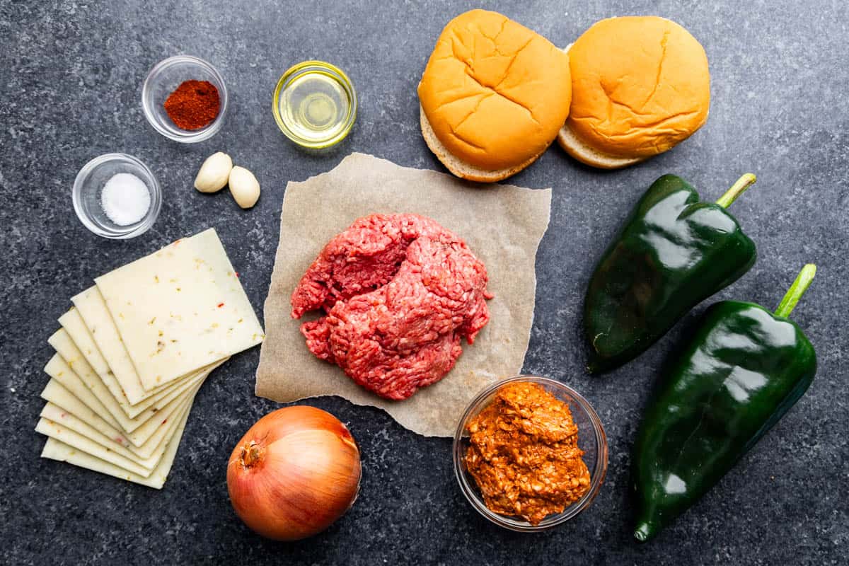 An overhead view of the ingredients needed to make a queso fundido chorizo hamburger.