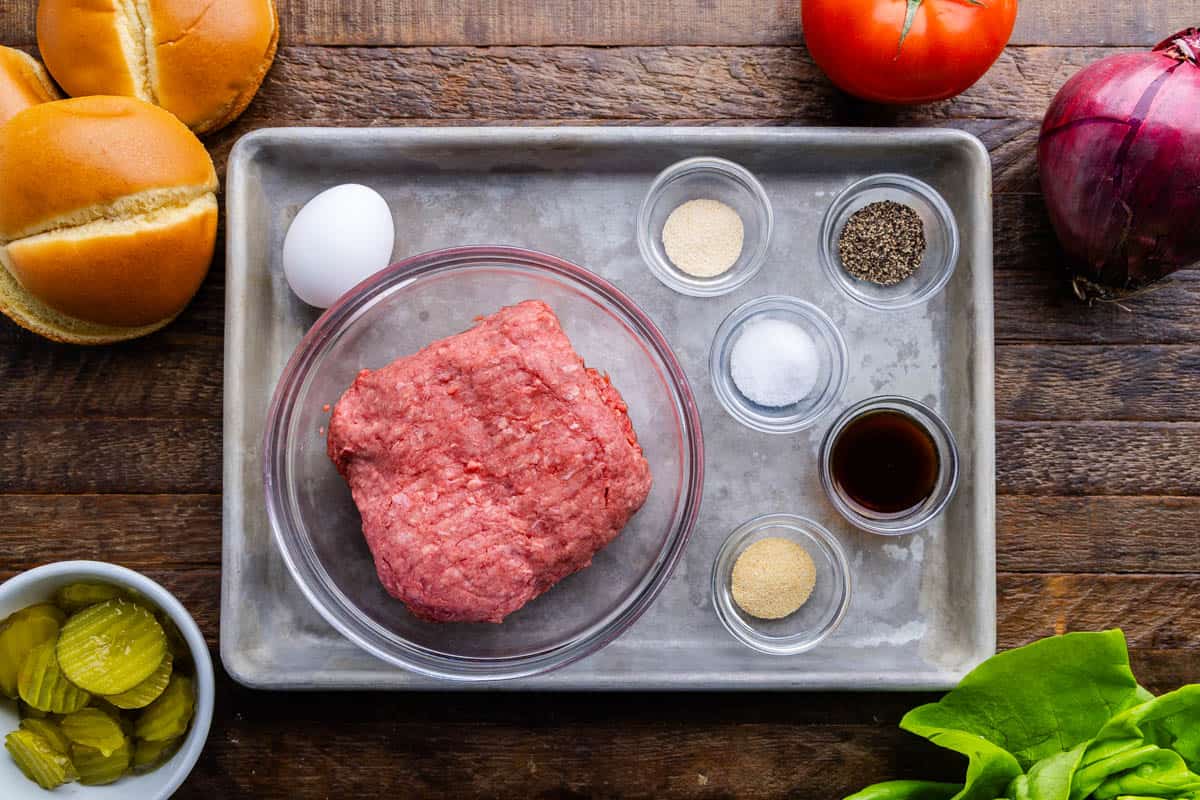 An overhead view of the ingredients needed to make smoked burgers.