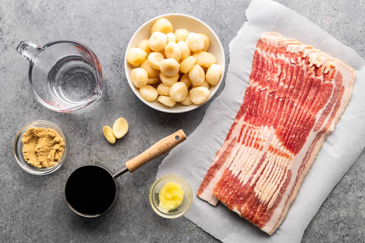 An overhead view of the ingredients needed to make bacon wrapped water chestnuts. 