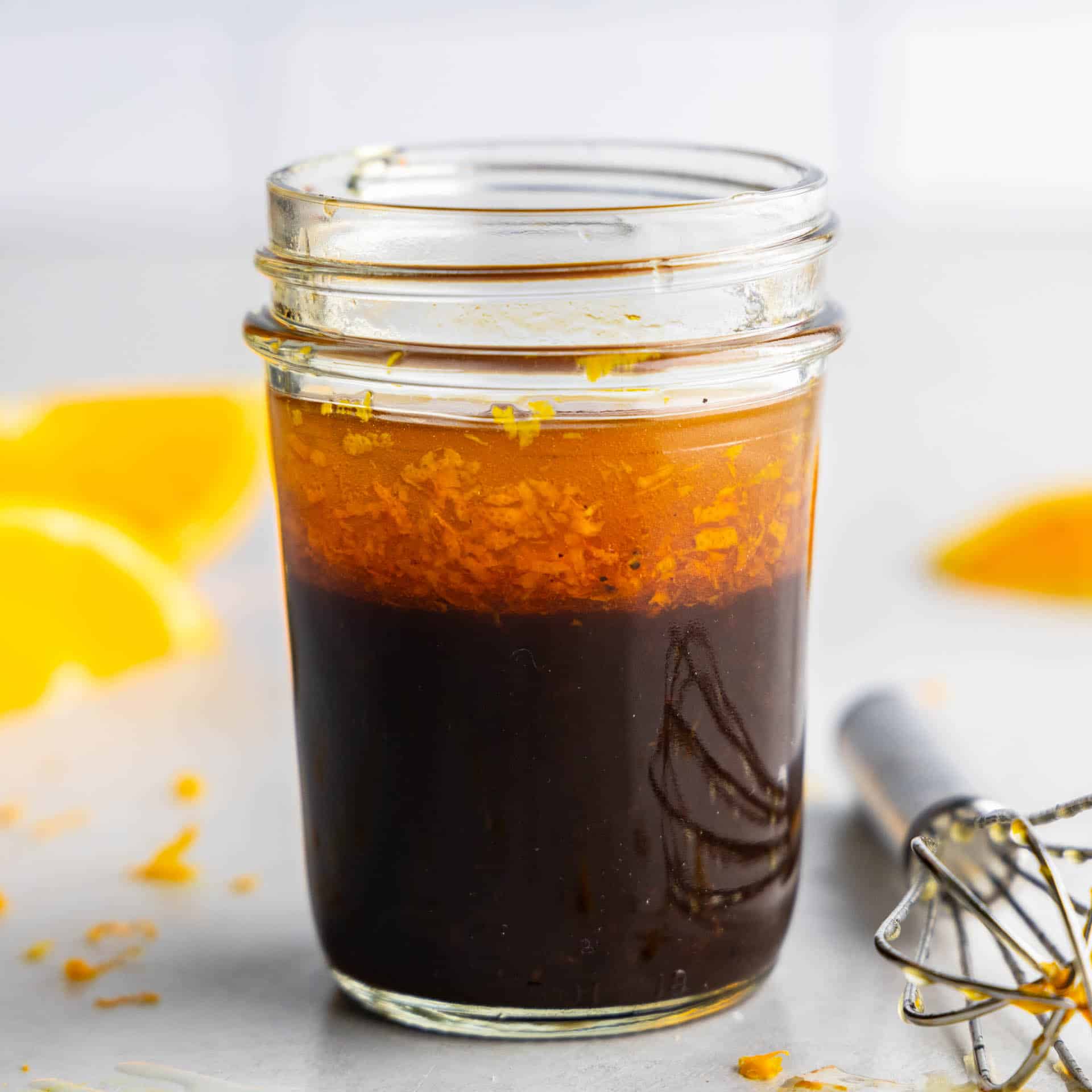 A jar of homemade orange balsamic vinaigrette.