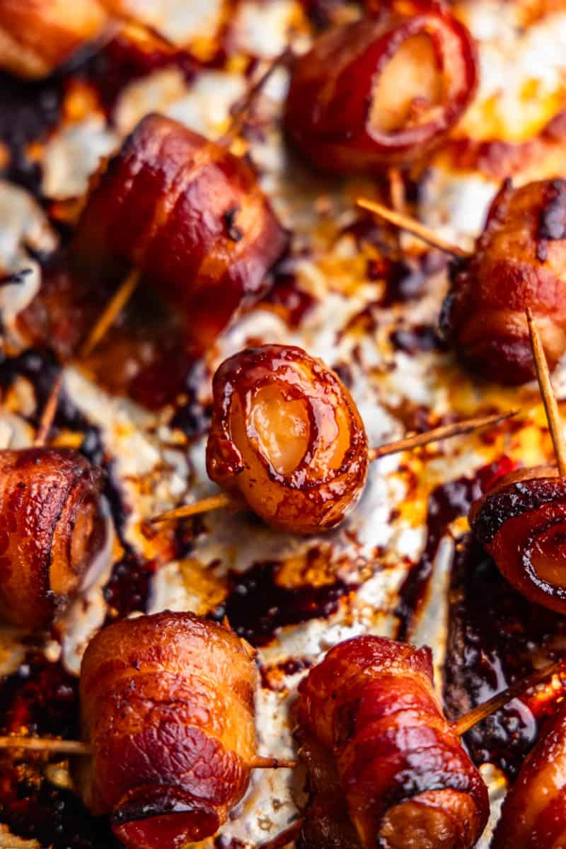 An overhead view of bacon wrapped water chestnuts on a baking sheet. 