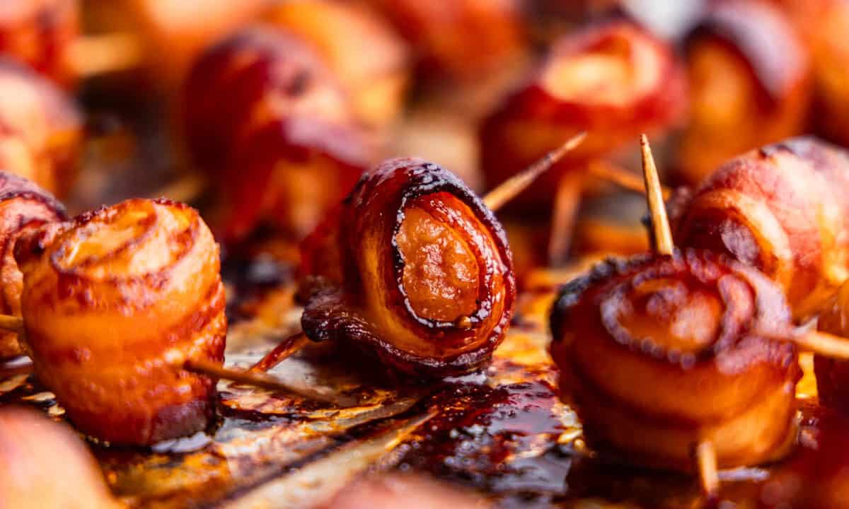 A close up view of bacon wrapped water chestnuts.