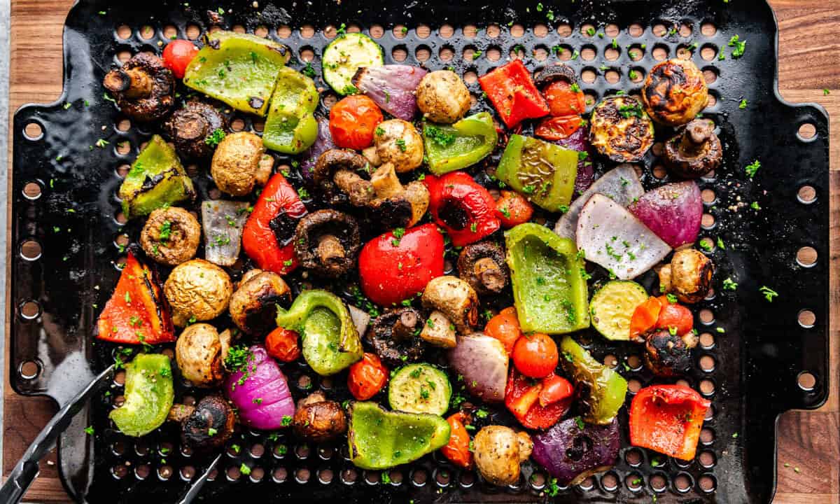 An overhead view of vegetables on a grill basket.