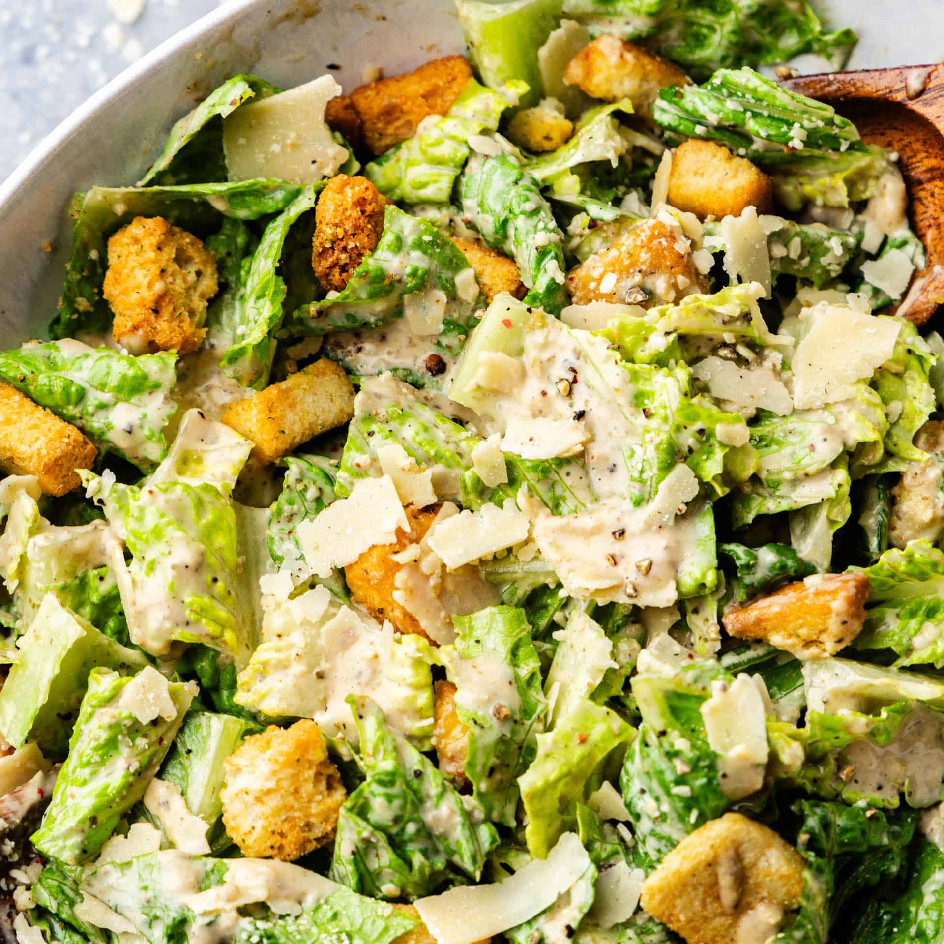 A bowl of classic Caesar salad on a table.