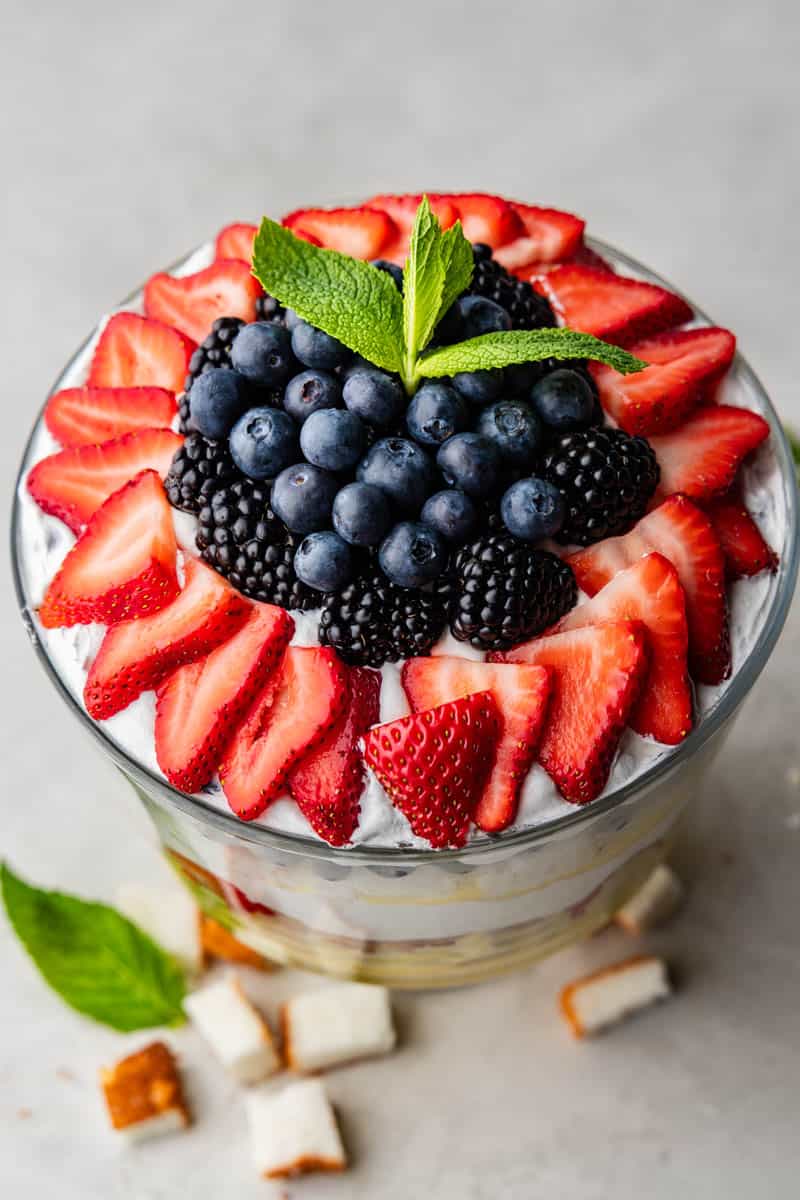 A view of the top of a creamy berry trio with a ring of strawberries along the edge and a pile of blueberries in the middle.